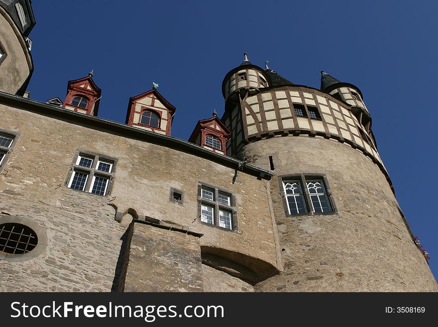 Strong and solid walls of an old german medieval castle with a deep blue sky in the background. Strong and solid walls of an old german medieval castle with a deep blue sky in the background