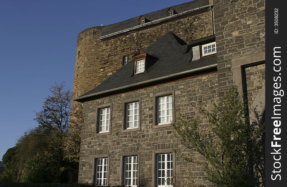 Strong and solid walls of an old german medievyl castle with a deep blue sky in the background. Strong and solid walls of an old german medievyl castle with a deep blue sky in the background