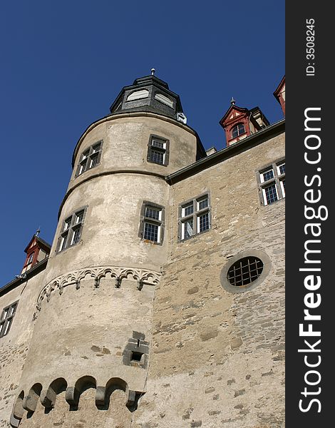 Tower of a medieval castle in Germany standing in the bright sunlight of a clear autumn day. Tower of a medieval castle in Germany standing in the bright sunlight of a clear autumn day