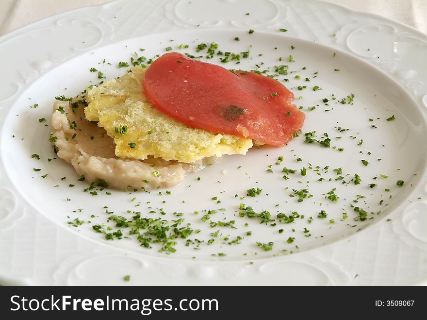 Italian dish with tomato, cheese and fish