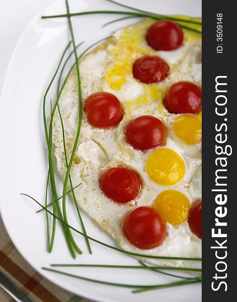 Fried eggs from eggs quail and tomatoes cherry