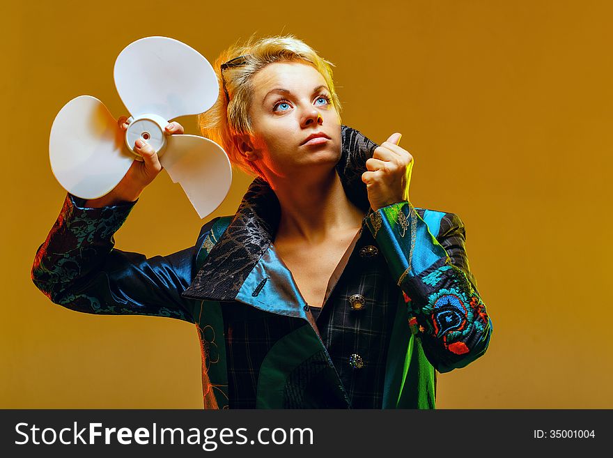 Girl in a jacket with a fan in hands, shot in the studio. Girl in a jacket with a fan in hands, shot in the studio