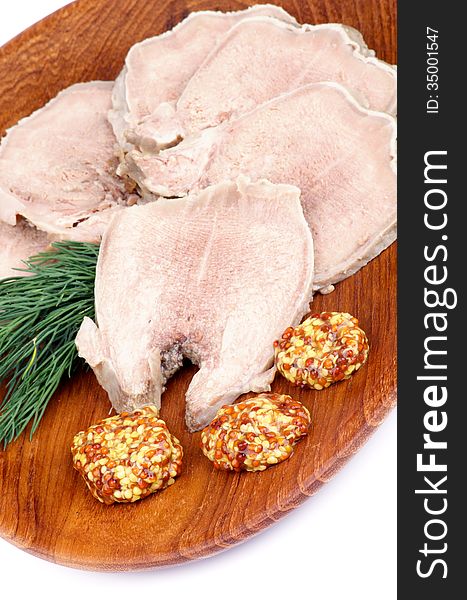 Slices of Delicious Boiled Beef Tongue with Whole Grain Mustard and Dill on Wooden Plate closeup