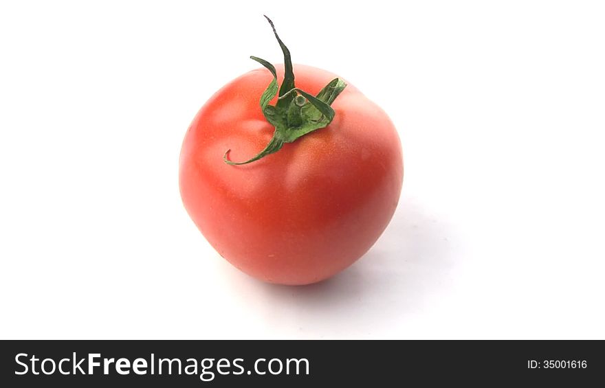 Juicy fresh tomato isolated spins around its axis. Juicy fresh tomato isolated spins around its axis