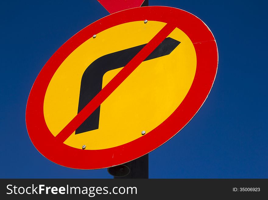 Vibrant road sign against clear blue sky. Vibrant road sign against clear blue sky