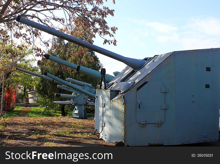 Turrets of canon by navy battle ship exposed on the ground.