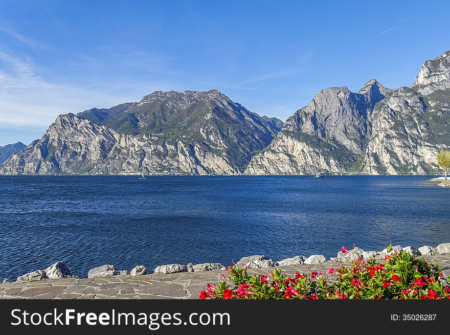 There is a magnificent view of Lake Garda and the mountains surrounding it from Torbole shore. There is a magnificent view of Lake Garda and the mountains surrounding it from Torbole shore.