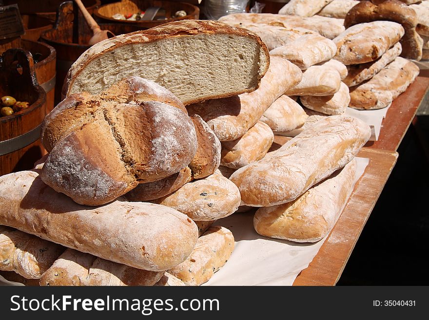 A Market Stall Selling a Variety of Bread Loaves.
