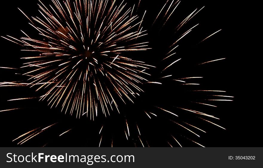 Multi volleys firework splits millions of lights in the night sky. Multi volleys firework splits millions of lights in the night sky