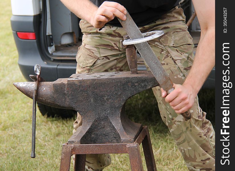 Working on a Horseshoe at a Vintage Blacksmith Anvil.