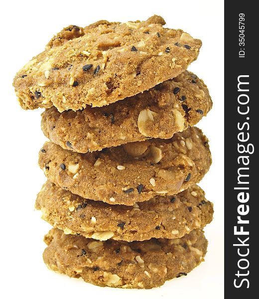 Tilted stack tower of whole grains cookies on white background. Tilted stack tower of whole grains cookies on white background