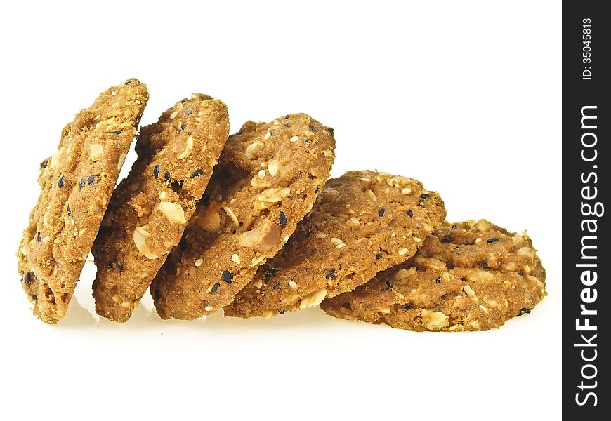 Step of pile whole grains cookies from stand to lie on white background. Step of pile whole grains cookies from stand to lie on white background