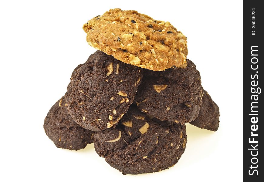 Pile of brownie cookies and light brown cookies on top on white background. Pile of brownie cookies and light brown cookies on top on white background