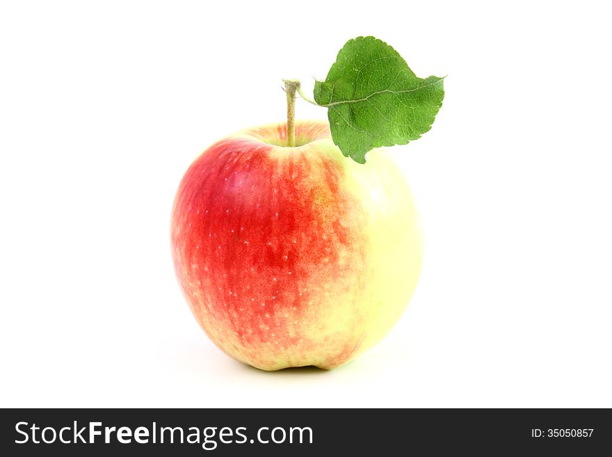 Big red apple with one green leaf isolated on a white background. Big red apple with one green leaf isolated on a white background