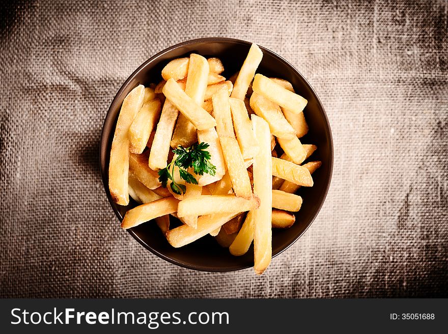 Fried French fries with red sauce ketchup on beautiful plate with linen background. Fried French fries with red sauce ketchup on beautiful plate with linen background