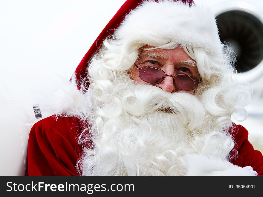 Profile of Santa Claus in front of airplane. Profile of Santa Claus in front of airplane