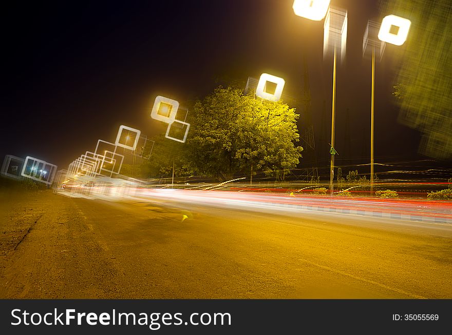 Road scene of traffic moving at night with colorful light trails with beautiful bokeh. Road scene of traffic moving at night with colorful light trails with beautiful bokeh