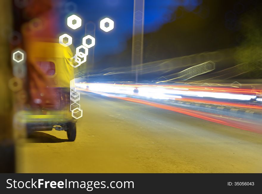 Moving auto rickshaw on road with light trails at night. Moving auto rickshaw on road with light trails at night