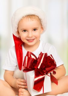 Little Cute Child Boy In A Christmas Hat With A Gift Stock Image Little Cute Child Boy In A Christmas Hat With A Gift Stock Image