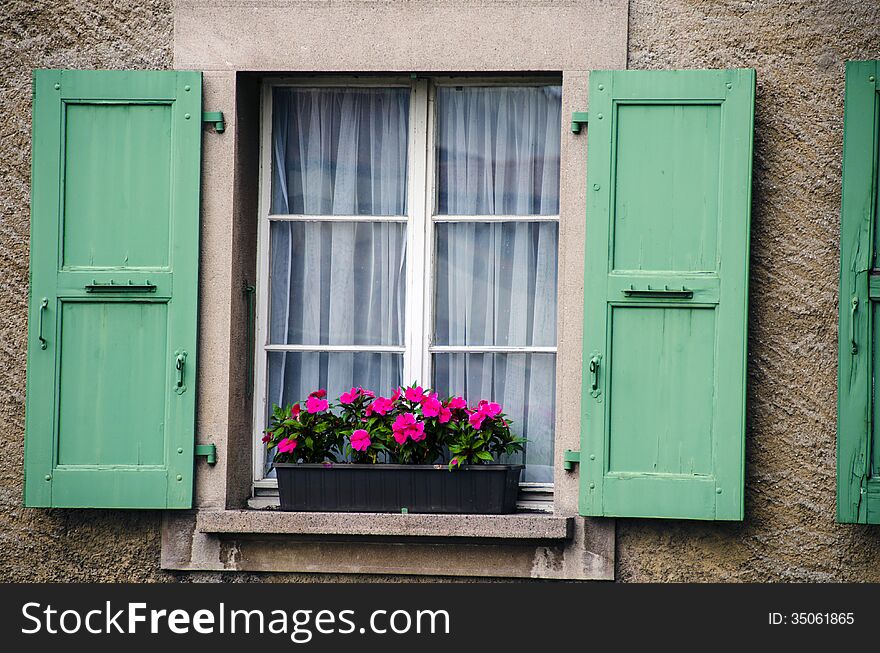 Window wth wood shutters and flowers