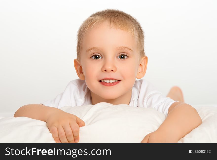 Happy child little boy  in bed