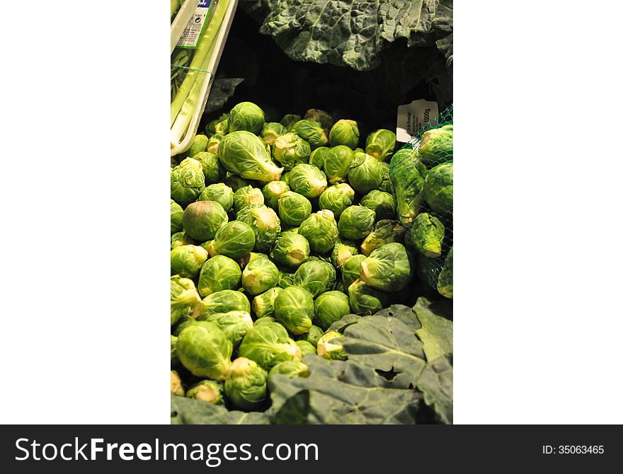 A pile of fresh green brussels sprouts .