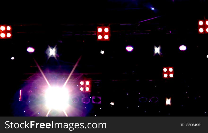 Blinking and moving lighting equipment (spotlights) on stage during a concert of jazz music. Blinking and moving lighting equipment (spotlights) on stage during a concert of jazz music