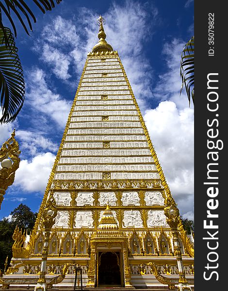 White and gold sharp square pagoda with cloud in temple country of Thailand.