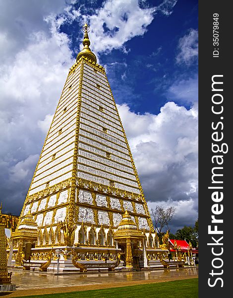 Sharp square pagoda with cloud in temple country of Thailand.
