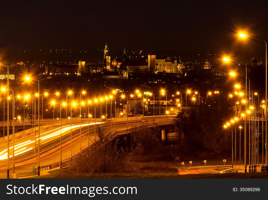 Royal Wawel castle by night with blurred traffic lights