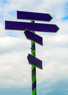 Signpost With Arrows Pointing On Sky Stock Photos