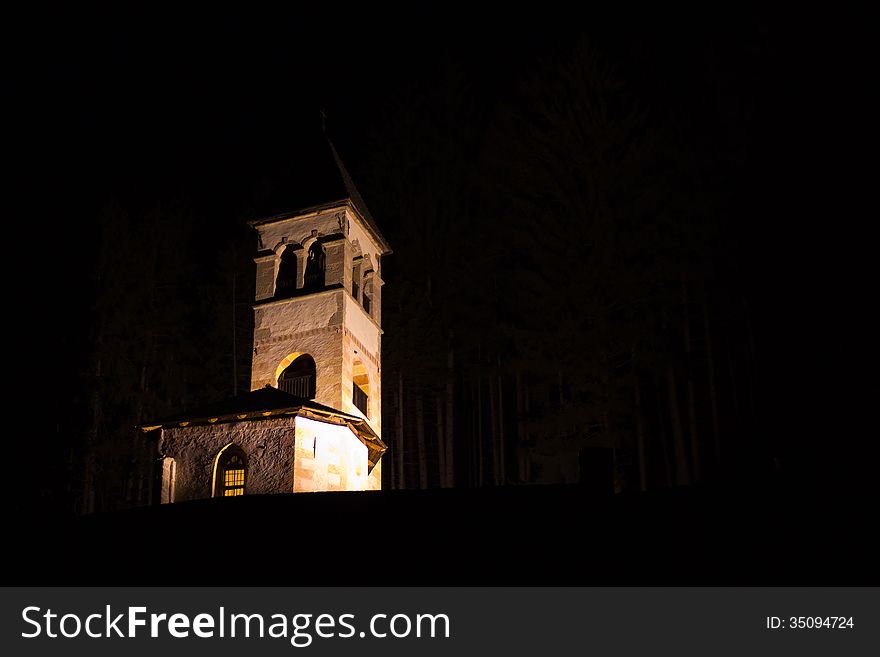 A church in the night, in a little town between mountains