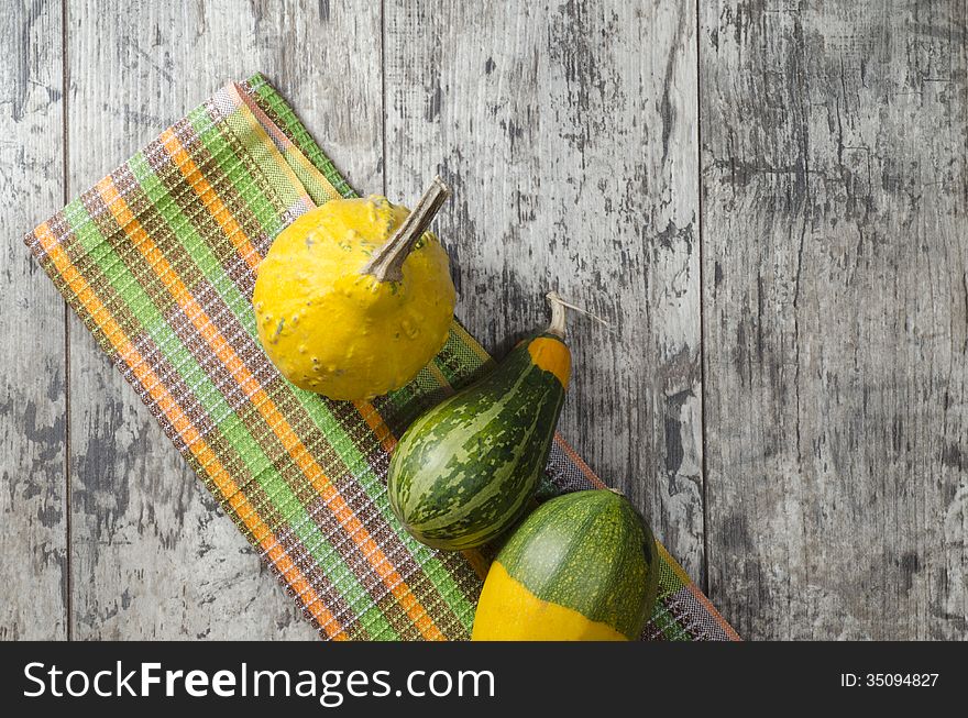 Small pumpkins on old table.