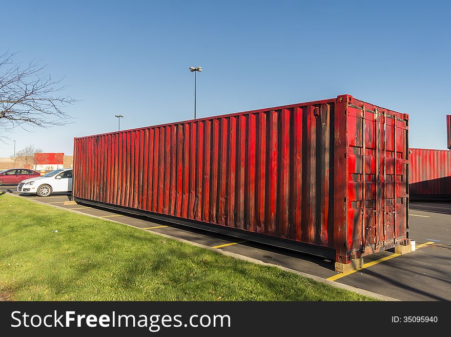 Red cargo container in a parking lot. Red cargo container in a parking lot