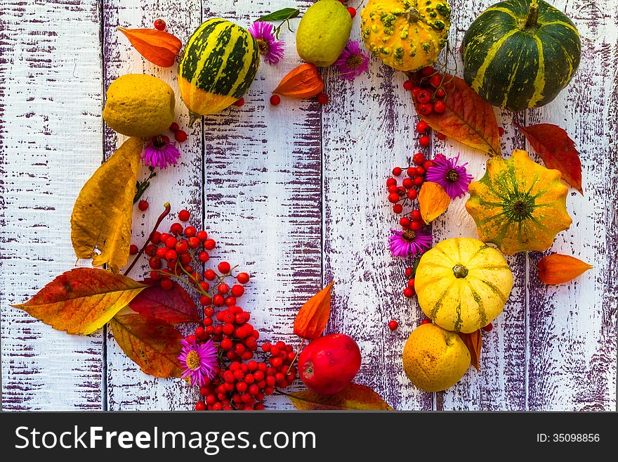 Autumn setting on the wooden table with fruits and vegetables. Autumn setting on the wooden table with fruits and vegetables