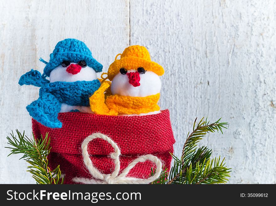 Plush soft snowmen on white wooden background. Plush soft snowmen on white wooden background