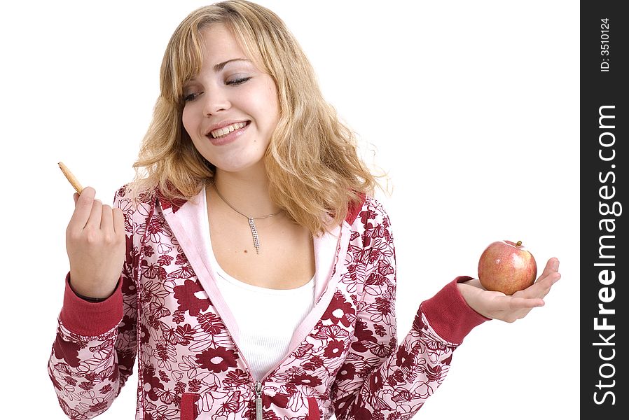 Teenage girl deciding between a nutritious snack and a sugary one. Teenage girl deciding between a nutritious snack and a sugary one.