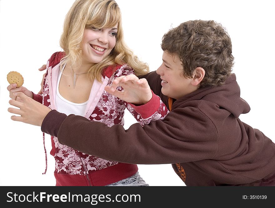 Boy trying to grab cookie away from his sister. Boy trying to grab cookie away from his sister