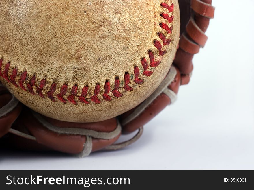 Baseball with red stitching and outfielders glove (mitt) on a white background,sports