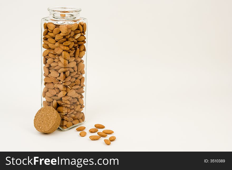 Almonds, one of the healthiest snacks, ready for eating out of a glass jar. Almonds, one of the healthiest snacks, ready for eating out of a glass jar.