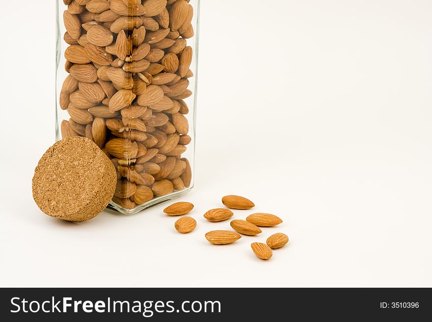 Almonds, one of the healthiest snacks, by a glass jar. Almonds, one of the healthiest snacks, by a glass jar.