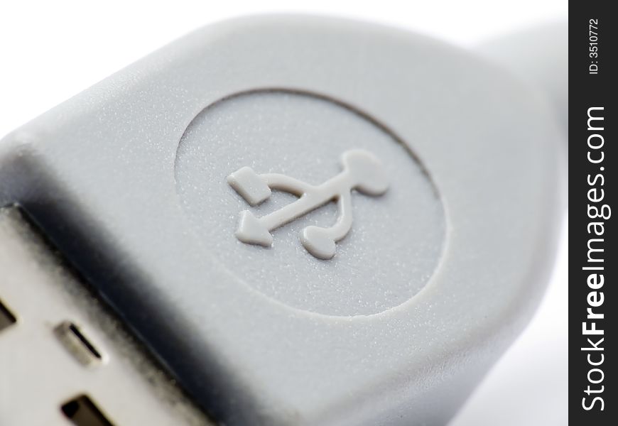 Extreme macroshot of an USB connector clearly showing the USB symbol