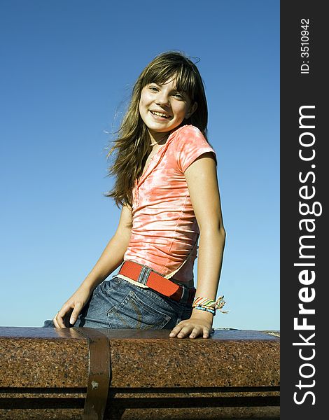 A portrait of a smiling girl on a background of the sky. A portrait of a smiling girl on a background of the sky