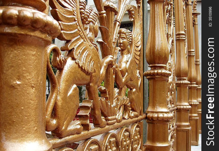 Ornate gold gates with griffins. Ornate gold gates with griffins