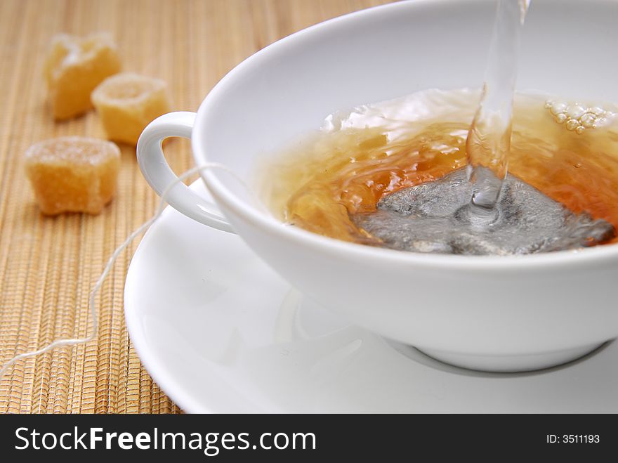 Hot water in a cup with a teabag. Hot water in a cup with a teabag