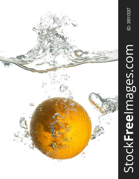 An orange falling in water