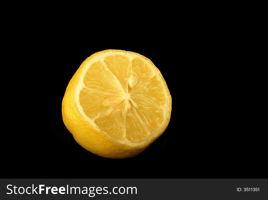 Half of fresh lemon on the black background