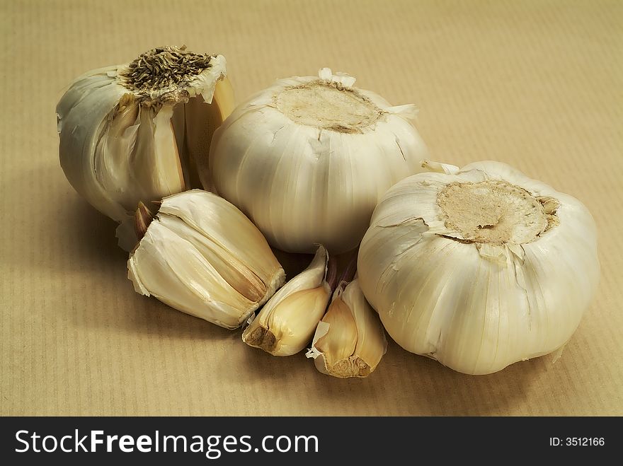 Garlic on brown paper horizontal, individual cloves. Garlic on brown paper horizontal, individual cloves