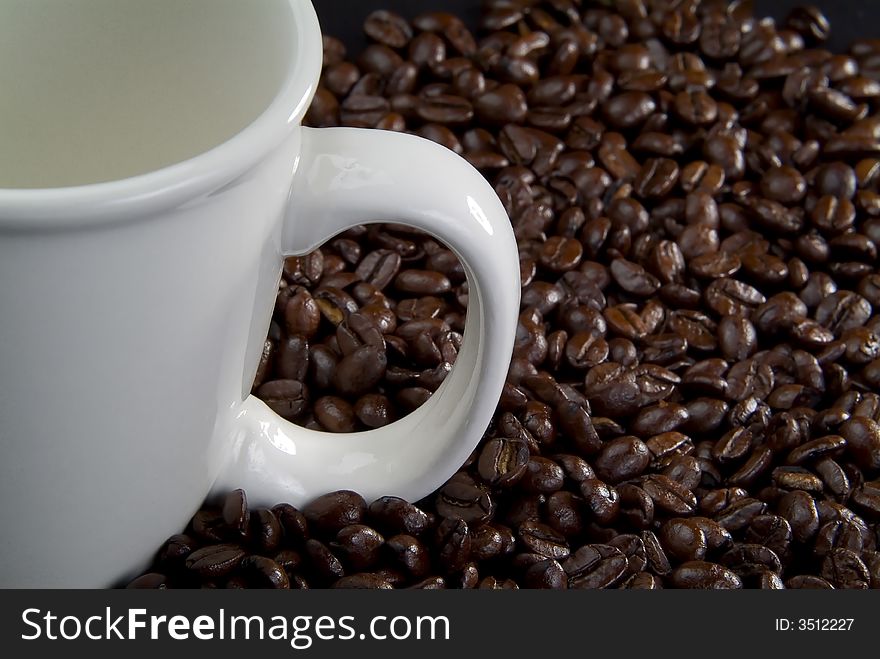 Coffee beans and white coffee cup. Coffee beans and white coffee cup