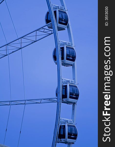 Ferris wheel against blue background